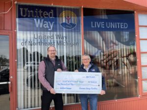 Rich Castle from Consumers Energy presenting a $4,000 check to Joe Gentry of United Way of Northeast Michigan.